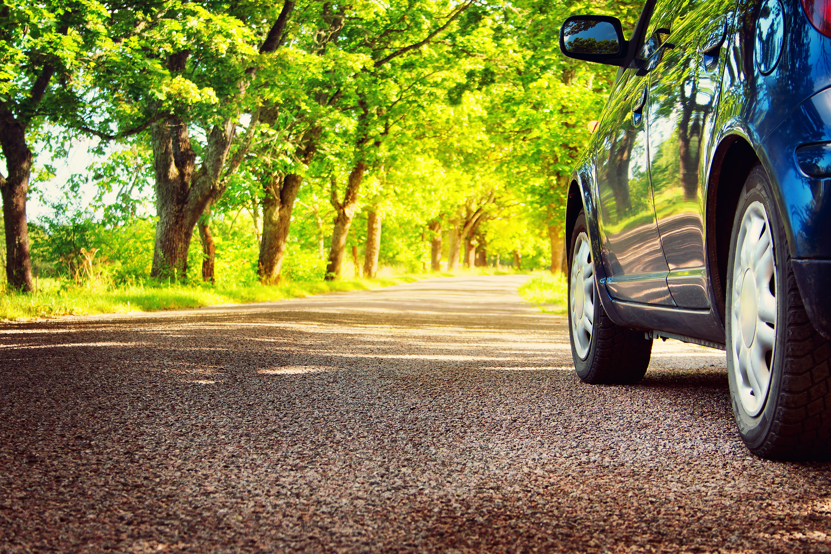 Car on asphalt road in summer 