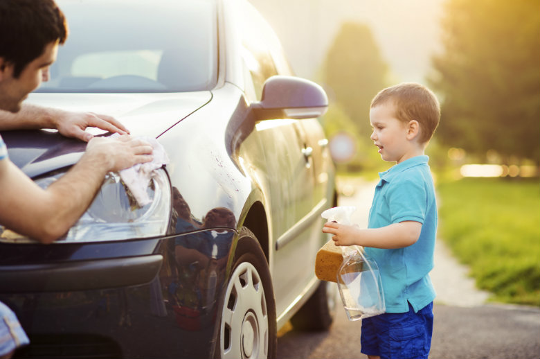 Father and son washing car