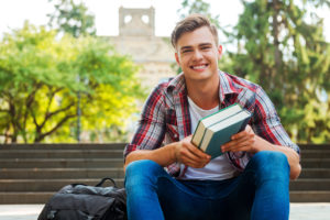 Student Holding Textbooks