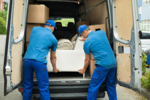 Two Workers Adjusting Sofa