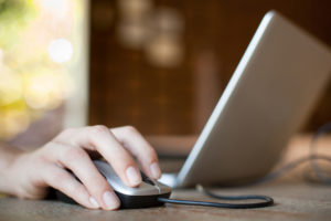 Woman hand with mouse and laptop