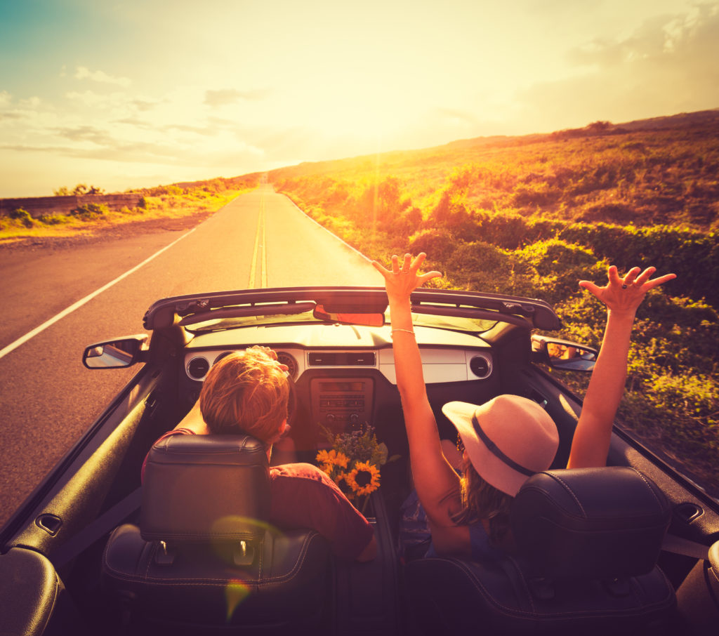 Couple driving convertible