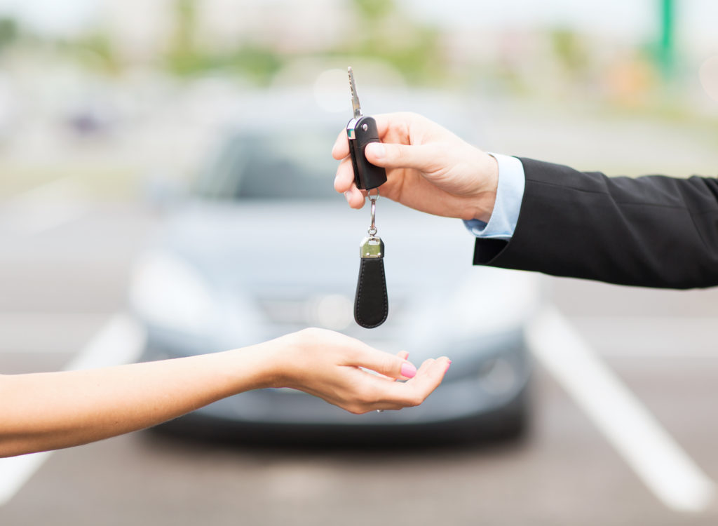 Customer and salesman with car key