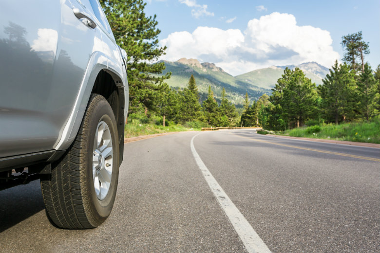 Silver Car Driving In Mountains